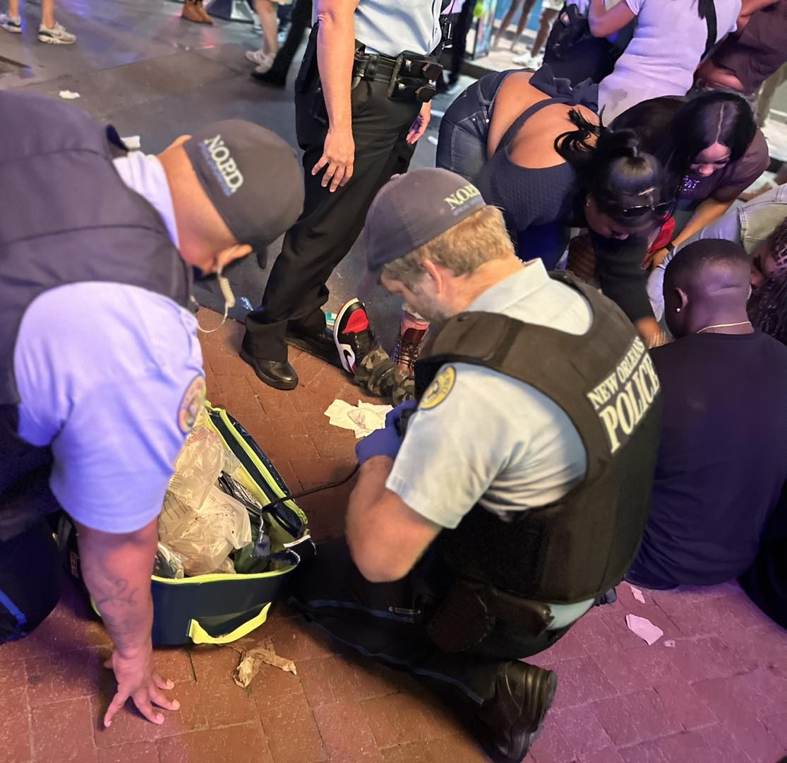 NOPD EMR Officer attending to an injured person on Bourbon Street in the Eighth District
